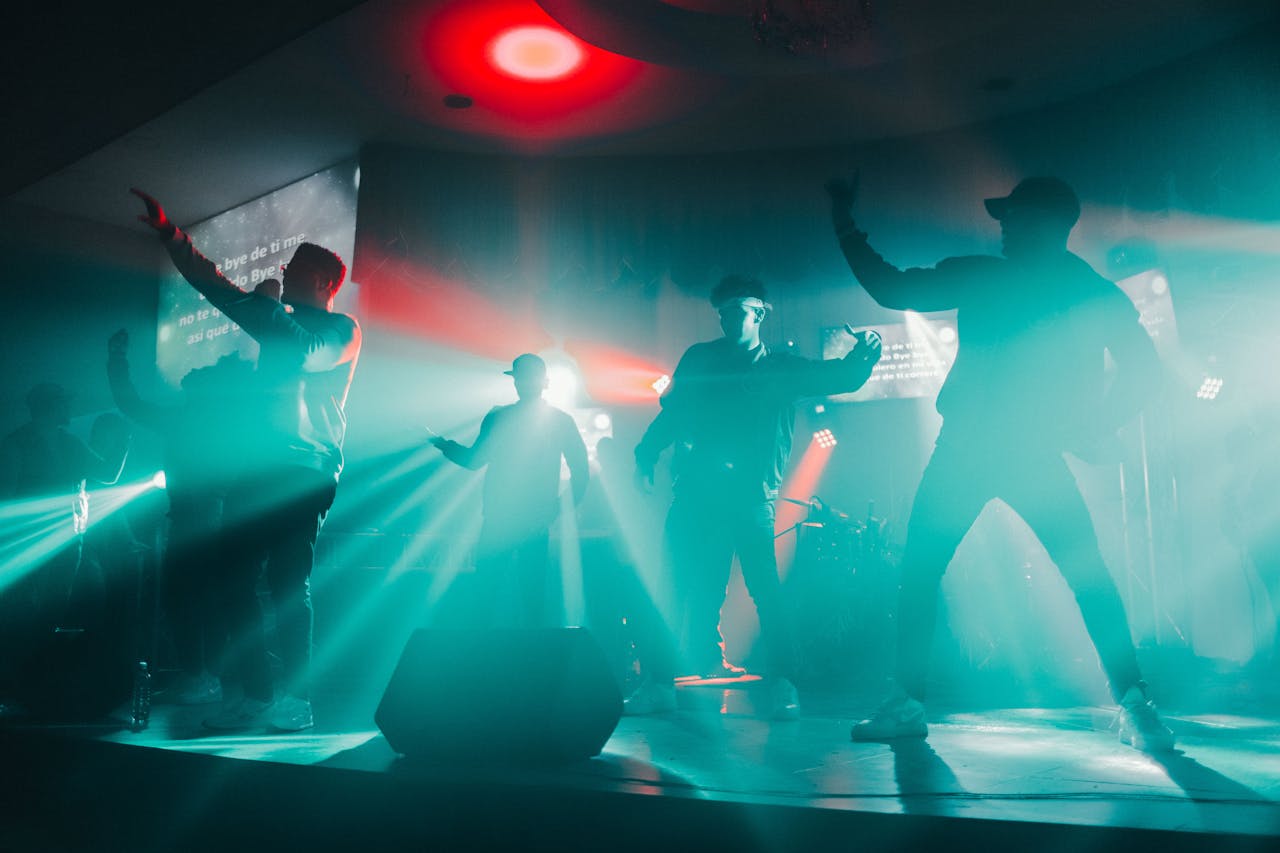 Dynamic concert scene with performers under vivid spotlights, creating an energetic atmosphere.